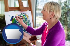 iowa map icon and an artist painting a picture