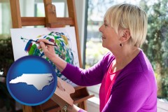 north-carolina map icon and an artist painting a picture